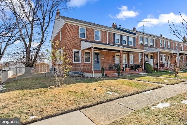 view of property featuring a front lawn and a porch