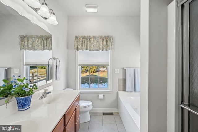 bathroom featuring toilet, vanity, a bath, and tile patterned flooring