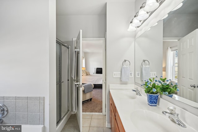 bathroom featuring tile patterned floors, an enclosed shower, and vanity