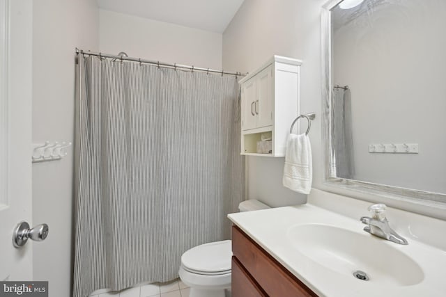 bathroom with walk in shower, tile patterned floors, vanity, and toilet