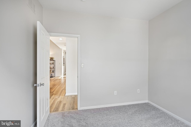 empty room featuring light carpet