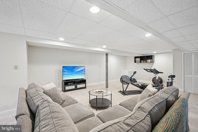 carpeted living room featuring a paneled ceiling