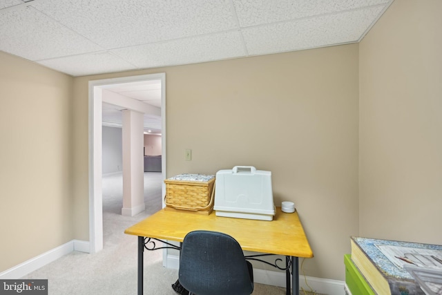 carpeted home office featuring a drop ceiling