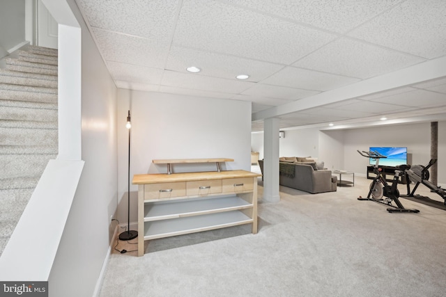 exercise room with carpet flooring and a drop ceiling