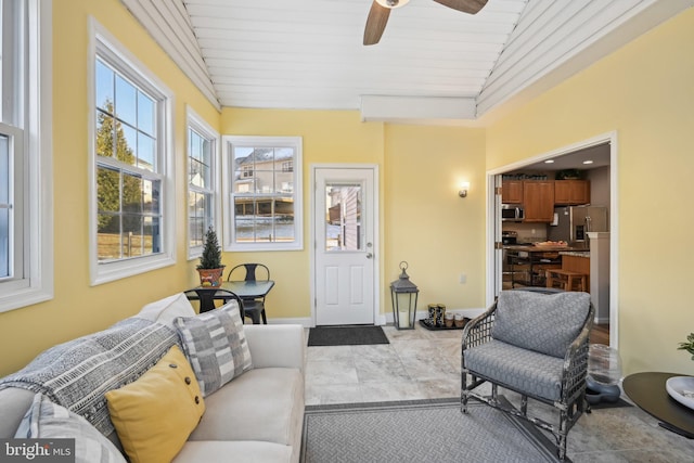 sunroom / solarium featuring lofted ceiling, wood ceiling, and ceiling fan