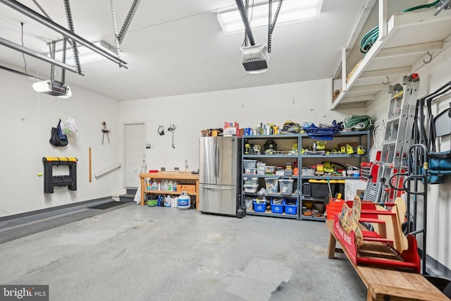 garage featuring a garage door opener, a workshop area, and stainless steel refrigerator