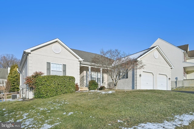 view of front of property with a garage and a yard