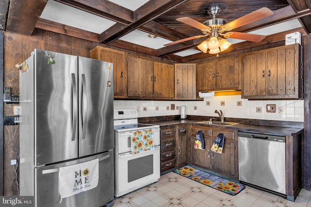 kitchen with coffered ceiling, sink, appliances with stainless steel finishes, ceiling fan, and beam ceiling