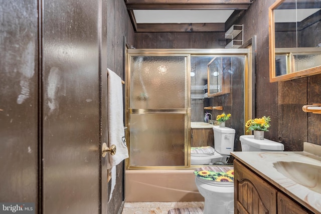 full bathroom with vanity, toilet, and combined bath / shower with glass door