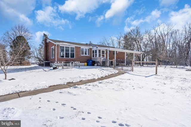 snow covered back of property with central air condition unit