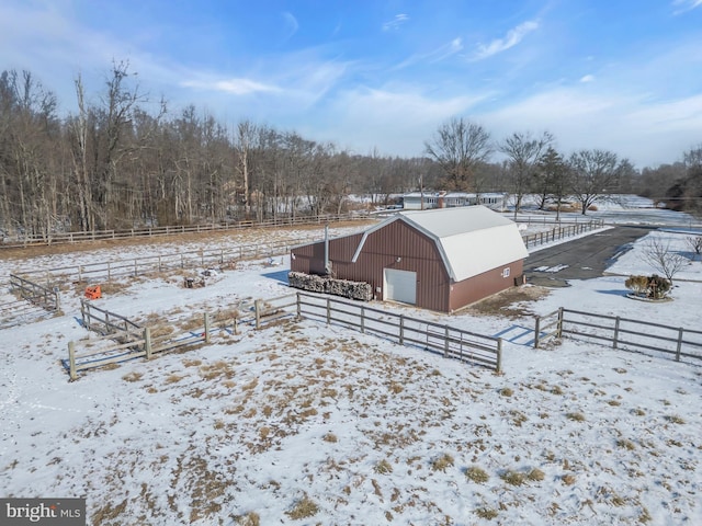 snow covered structure featuring a rural view