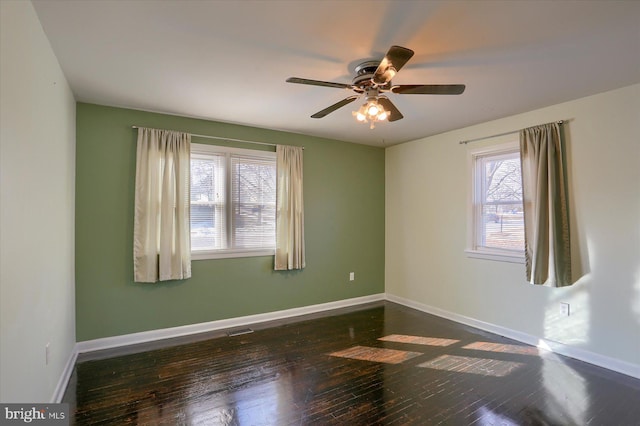 spare room with ceiling fan and dark hardwood / wood-style floors