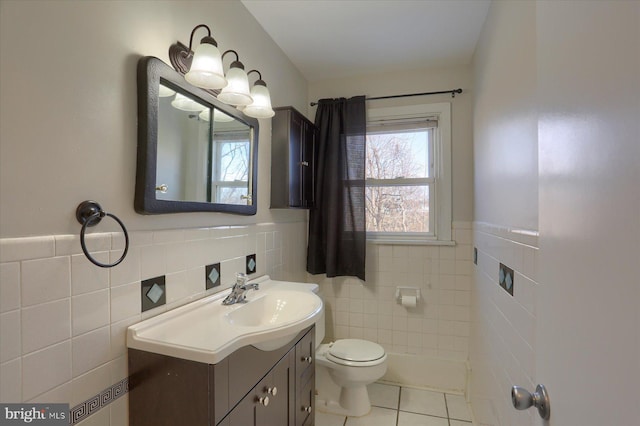 bathroom featuring vanity, tile patterned floors, toilet, and tile walls