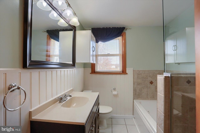 bathroom with a tub, tile patterned floors, vanity, and a wealth of natural light