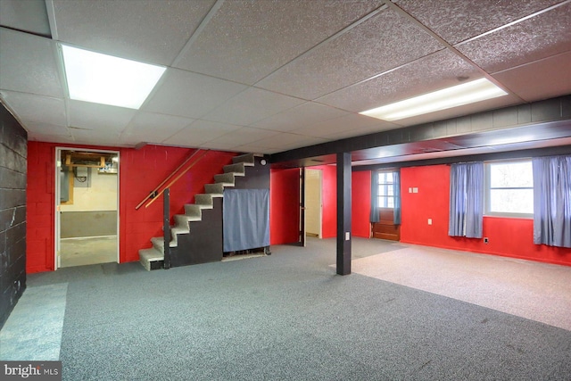 basement with carpet and a drop ceiling