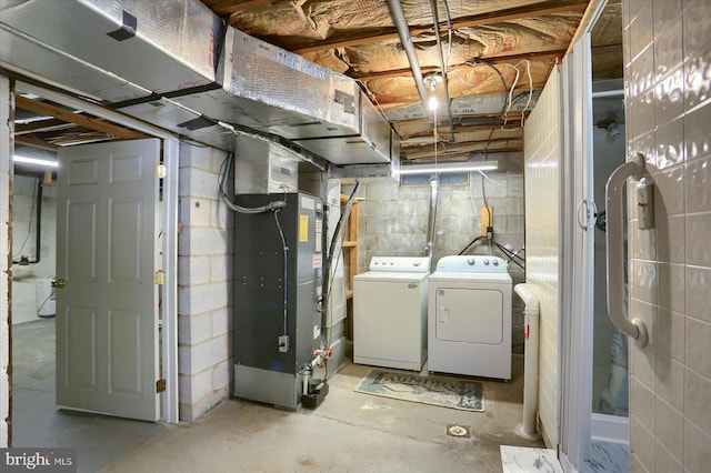 basement with heating unit and washing machine and dryer