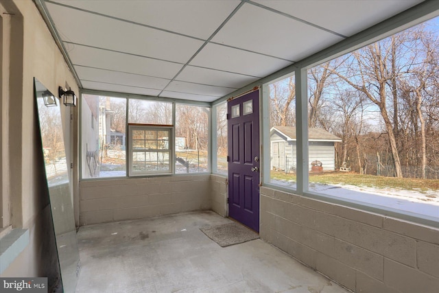 unfurnished sunroom with a paneled ceiling