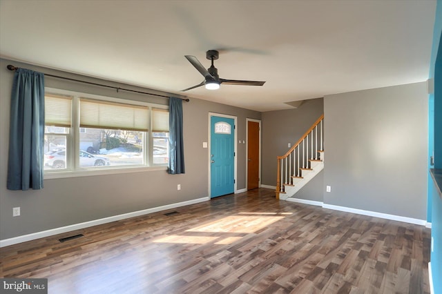 entryway with ceiling fan and dark hardwood / wood-style flooring