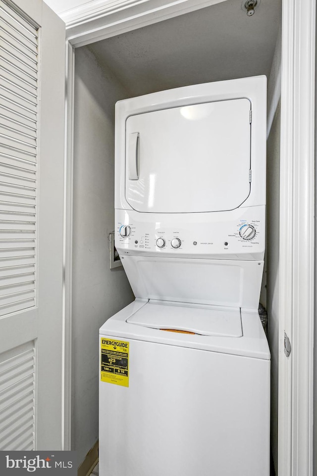 laundry room with stacked washer / drying machine