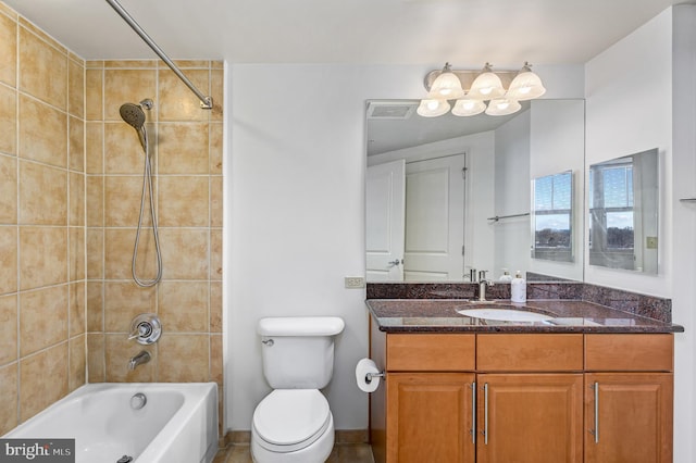 full bathroom with tiled shower / bath combo, vanity, and toilet