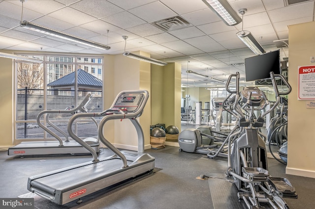 exercise room featuring a drop ceiling