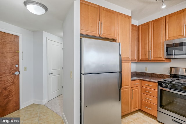 kitchen with stainless steel appliances and light tile patterned floors