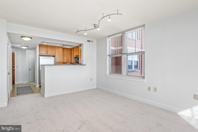 unfurnished living room with light carpet