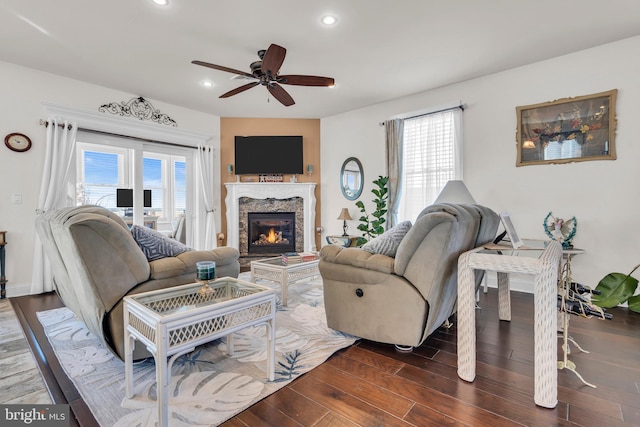 living room with ceiling fan, a fireplace, and a healthy amount of sunlight