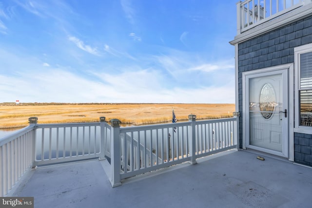 view of patio / terrace featuring a rural view and a balcony