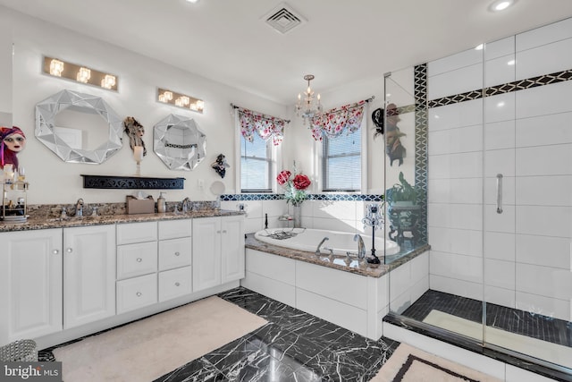 bathroom featuring vanity and independent shower and bath