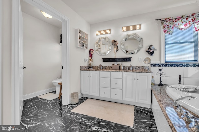 bathroom with vanity and a washtub