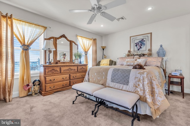 bedroom with ceiling fan and light colored carpet