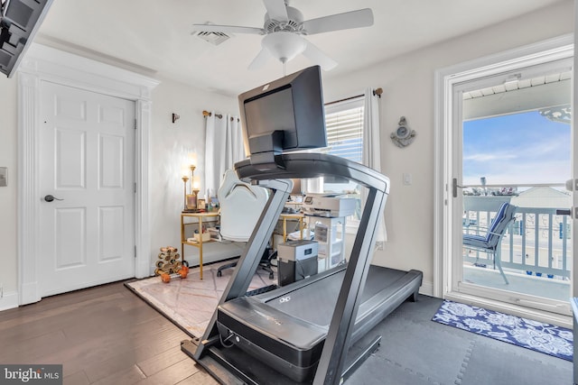 workout area with dark wood-type flooring and ceiling fan