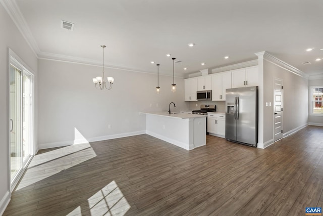 kitchen with stainless steel appliances, dark hardwood / wood-style floors, white cabinets, and decorative light fixtures