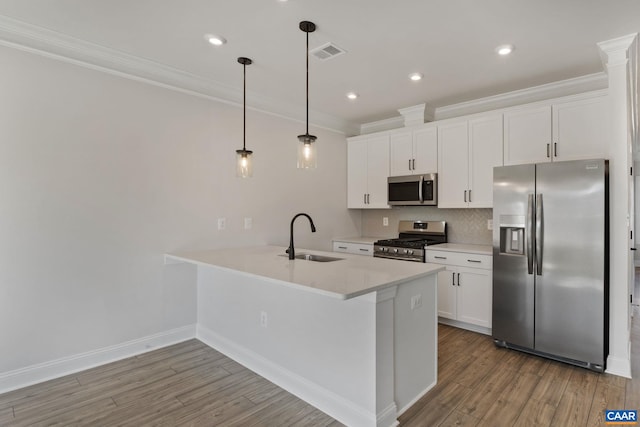 kitchen with sink, hanging light fixtures, stainless steel appliances, light hardwood / wood-style floors, and white cabinets