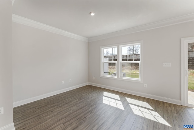 empty room with crown molding and dark hardwood / wood-style floors