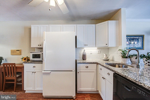 kitchen with light stone counters, sink, white appliances, and white cabinets