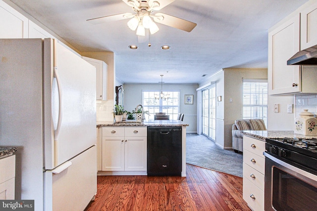 kitchen with stainless steel gas range oven, white refrigerator, black dishwasher, decorative backsplash, and white cabinets