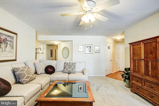 living room featuring ceiling fan and light colored carpet