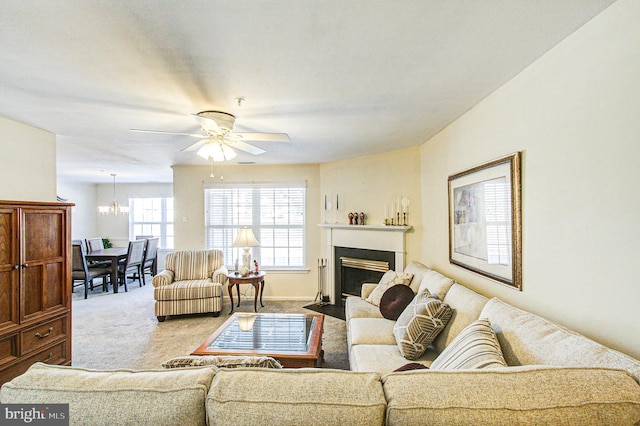 living room with carpet floors and ceiling fan with notable chandelier