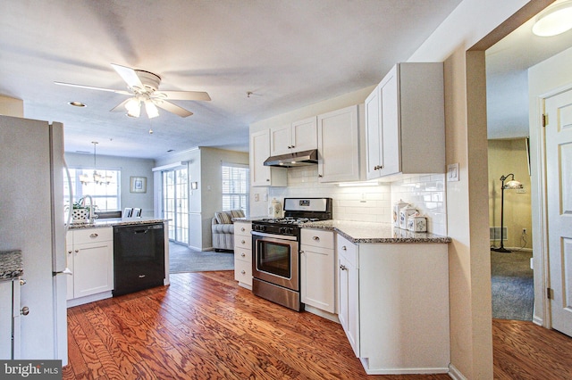 kitchen featuring stainless steel gas range, white cabinetry, hanging light fixtures, white refrigerator, and dishwasher