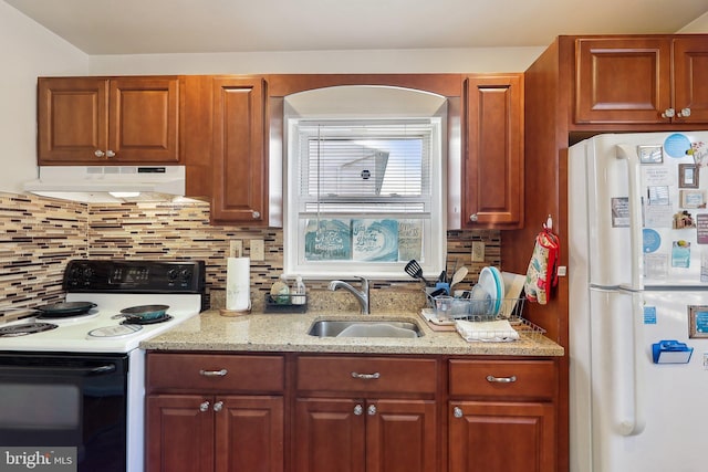 kitchen featuring range with electric stovetop, white fridge, sink, and decorative backsplash