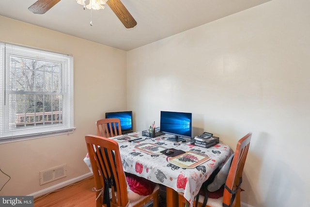 dining room with hardwood / wood-style flooring and ceiling fan