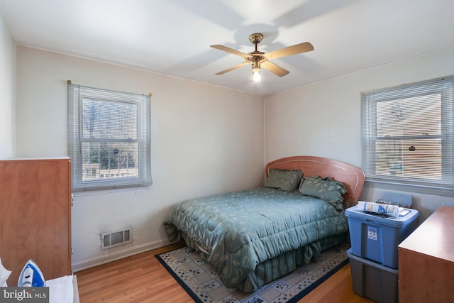 bedroom with ceiling fan and light hardwood / wood-style flooring