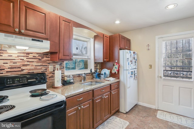 kitchen with sink, white refrigerator, black range with electric cooktop, light stone countertops, and backsplash