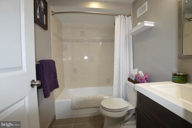 full bathroom featuring vanity, tile patterned floors, toilet, and shower / bath combo