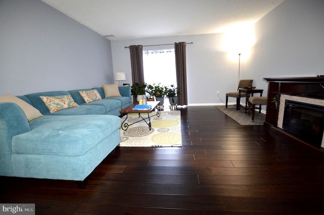 living room with dark wood-type flooring and lofted ceiling