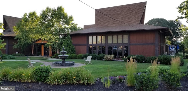 back of house featuring a lawn