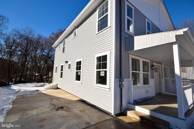 view of snow covered exterior featuring a balcony