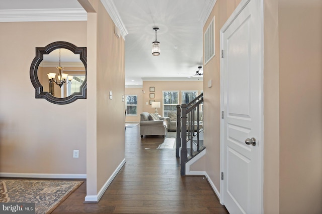 corridor with crown molding, dark hardwood / wood-style floors, and a chandelier